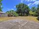 Spacious backyard featuring mature trees and a patio at 1600 Alma Ct, Bartow, FL 33830