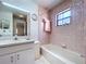 Classic bathroom features a shower-tub combination, vanity, and decorative wallpaper at 1600 Alma Ct, Bartow, FL 33830