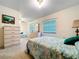Bright bedroom with two beds, dresser, and natural light through large window at 1600 Alma Ct, Bartow, FL 33830