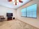 Clean bedroom with a chair and television next to a bright window at 1600 Alma Ct, Bartow, FL 33830