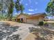 Lovely home featuring an attached garage, driveway, and manicured landscaping at 1600 Alma Ct, Bartow, FL 33830