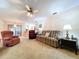Inviting living room with ceiling fan, neutral carpet, and sliding glass doors to lanai at 1600 Alma Ct, Bartow, FL 33830