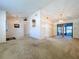 Large living room with vaulted ceilings, neutral carpet, and sliding glass doors leading to the patio at 1600 Alma Ct, Bartow, FL 33830