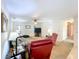 A well-lit living room features comfy seating, a ceiling fan, and a television for enjoying time at home at 1600 Alma Ct, Bartow, FL 33830