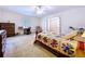 Comfortable main bedroom with a ceiling fan, desk, and plenty of natural light at 1600 Alma Ct, Bartow, FL 33830