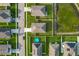 An aerial view of the neighborhood showcases the houses, lawns, and nearby pond at 1835 Jackson Oaks Dr, Bartow, FL 33830
