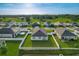 An aerial view of the home features its well-manicured lawn and fencing at 1835 Jackson Oaks Dr, Bartow, FL 33830