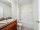 The bathroom features a single sink vanity, a mirror, a tiled floor, and a shower and tub combo at 1835 Jackson Oaks Dr, Bartow, FL 33830