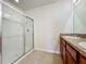 Bright bathroom with a tile floor, walk-in shower with glass door, and vanity at 1835 Jackson Oaks Dr, Bartow, FL 33830