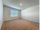 Bedroom featuring neutral carpet, white walls and window with horizontal blinds at 1835 Jackson Oaks Dr, Bartow, FL 33830