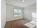 This bedroom is filled with natural light, neutral carpet, and offers a simple aesthetic at 1835 Jackson Oaks Dr, Bartow, FL 33830