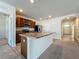 Bright kitchen with stainless appliances, brown cabinets, and large island with sink at 1835 Jackson Oaks Dr, Bartow, FL 33830