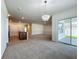 Living room with chandelier, open floor plan, and sliding glass doors to the patio at 1835 Jackson Oaks Dr, Bartow, FL 33830