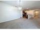 Spacious living room featuring neutral carpeting, white walls, and view of the kitchen at 1835 Jackson Oaks Dr, Bartow, FL 33830