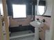 Tiled bathroom featuring a pedestal sink and shower with a window at 1835 Mount Pisgah Rd, Fort Meade, FL 33841