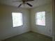 Bedroom features natural light from two windows and a ceiling fan at 1835 Mount Pisgah Rd, Fort Meade, FL 33841