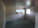 Simple bedroom featuring green carpet and window unit air conditioner at 1835 Mount Pisgah Rd, Fort Meade, FL 33841