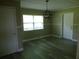 Dining room features neutral paint, ceiling fan, and a large window at 1835 Mount Pisgah Rd, Fort Meade, FL 33841