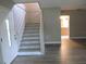 Entryway featuring staircase to the second level and wood-look laminate floors at 1835 Mount Pisgah Rd, Fort Meade, FL 33841