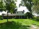 Charming two-story home featuring a brick facade, inviting front porch, and mature trees at 1835 Mount Pisgah Rd, Fort Meade, FL 33841