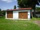 Exterior shot of detached garage featuring rustic wooden doors and ample storage space at 1835 Mount Pisgah Rd, Fort Meade, FL 33841