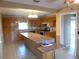 Kitchen featuring wood cabinets, tile floors, and a center island with seating at 1835 Mount Pisgah Rd, Fort Meade, FL 33841