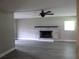 Living room featuring gray laminate floors and fireplace with brick surround at 1835 Mount Pisgah Rd, Fort Meade, FL 33841