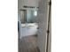 Well-lit bathroom featuring a double vanity and a large mirror at 184 Ocean Bluff Dr, Poinciana, FL 34759