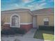 Charming one-story home featuring a well-maintained lawn and welcoming entryway at 184 Ocean Bluff Dr, Poinciana, FL 34759