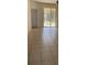 Open concept living room with tile floors and sliding glass doors to the patio at 184 Ocean Bluff Dr, Poinciana, FL 34759