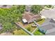Aerial view of a home with a fully fenced backyard, screened in patio, and well-maintained landscaping at 1850 Saddlewood Pl, Bartow, FL 33830