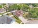 Aerial view of a home with well-maintained lawn, driveway, and landscaping surrounded by mature trees at 1850 Saddlewood Pl, Bartow, FL 33830