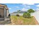 A spacious backyard features a white fence, green grass, and a small tree, providing a private outdoor space at 1850 Saddlewood Pl, Bartow, FL 33830