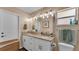 Bathroom with double sink vanity, granite countertops, and framed mirror at 1850 Saddlewood Pl, Bartow, FL 33830