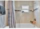 Modern bathroom showcasing a tiled shower/tub combo, and a small window offering natural light at 1850 Saddlewood Pl, Bartow, FL 33830