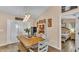 A sun-soaked dining room featuring a long wood table, natural lighting, hardwood floors, and open concept living at 1850 Saddlewood Pl, Bartow, FL 33830