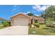 Charming one-story home with a two-car garage and well-maintained landscaping in a suburban neighborhood at 1850 Saddlewood Pl, Bartow, FL 33830