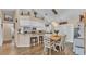 Bright, open-concept kitchen and dining area featuring granite countertops, a breakfast bar, and stainless appliances at 1850 Saddlewood Pl, Bartow, FL 33830