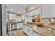Spacious kitchen featuring granite countertops, stainless steel appliances, white cabinetry and hardwood floors at 1850 Saddlewood Pl, Bartow, FL 33830