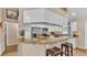 Modern kitchen showcasing granite countertops, stainless steel appliances, white cabinets, and barstool seating at 1850 Saddlewood Pl, Bartow, FL 33830