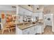 Open kitchen featuring granite countertops, white cabinets, and wood-look flooring at 1850 Saddlewood Pl, Bartow, FL 33830