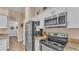 Updated kitchen with stainless steel appliances, granite countertops, and wood-look flooring at 1850 Saddlewood Pl, Bartow, FL 33830