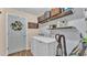 Laundry room with washer, dryer, overhead shelving and room to store supplies at 1850 Saddlewood Pl, Bartow, FL 33830
