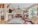 Comfortable living room featuring hardwood floors, leather sofas, natural lighting, and vaulted ceiling at 1850 Saddlewood Pl, Bartow, FL 33830