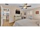 Comfortable main bedroom with wood floors, ceiling fan, and access to the main bathroom at 1850 Saddlewood Pl, Bartow, FL 33830