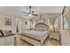 Bright main bedroom with wood floors, ceiling fan, and ensuite bathroom at 1850 Saddlewood Pl, Bartow, FL 33830