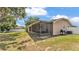 A screened patio offers an outdoor space for dining or relaxing, accessible from the backyard and house at 1850 Saddlewood Pl, Bartow, FL 33830