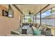 Spacious screened-in patio with comfortable seating, ceiling fan, and mounted TV for outdoor enjoyment at 1850 Saddlewood Pl, Bartow, FL 33830