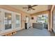 Relaxing screened-in patio with a ceiling fan, seating, and convenient mini-fridge at 1850 Saddlewood Pl, Bartow, FL 33830