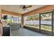 Cozy screened-in patio with comfortable wicker furniture and a ceiling fan at 1850 Saddlewood Pl, Bartow, FL 33830
